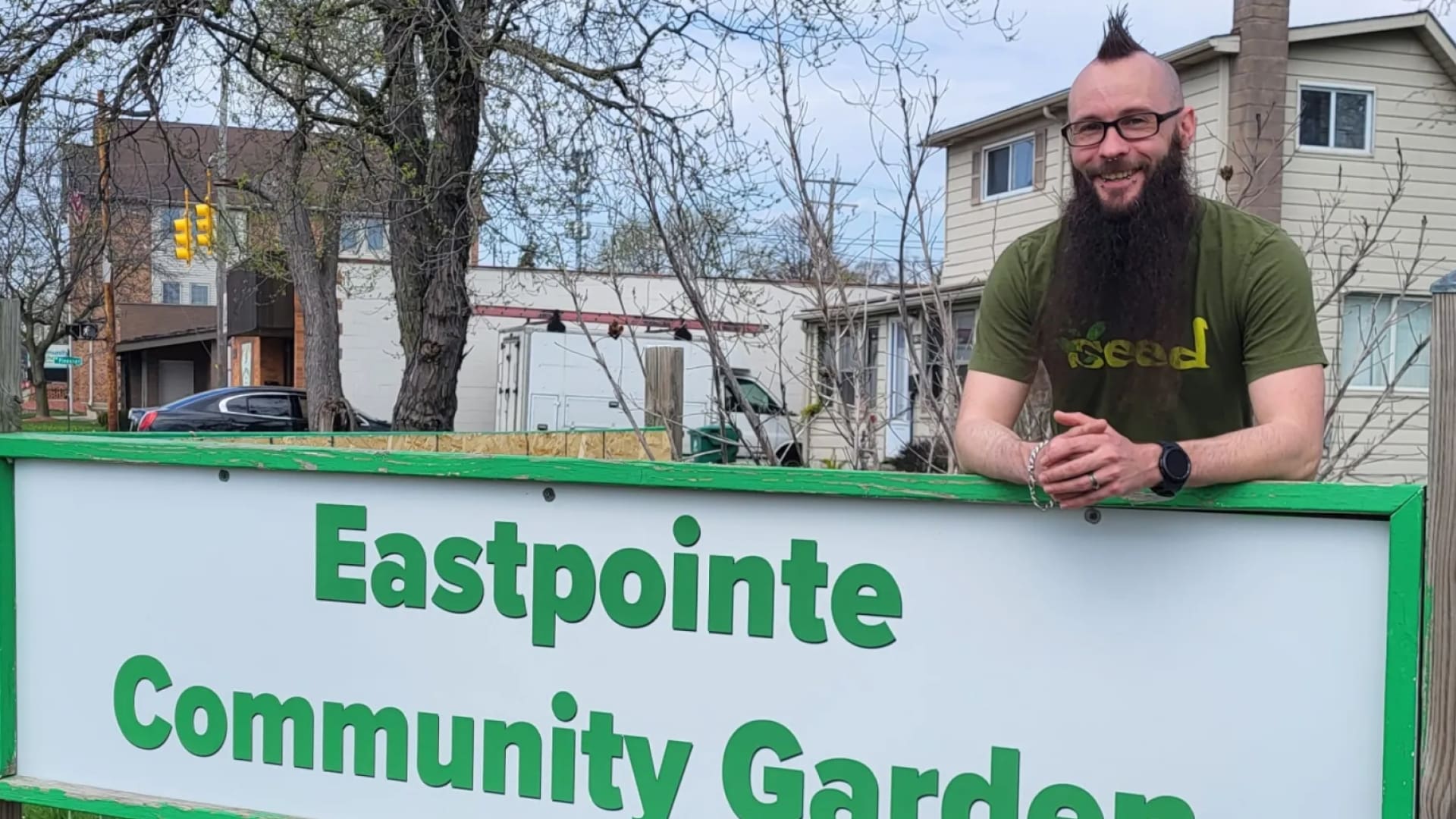 John with community garden sign